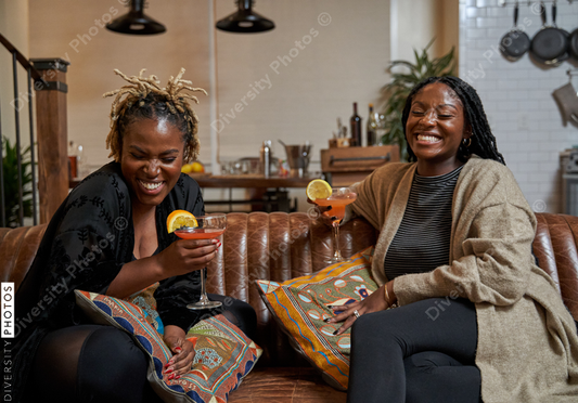 Black girlfriends talking at home during cozy self care retreat