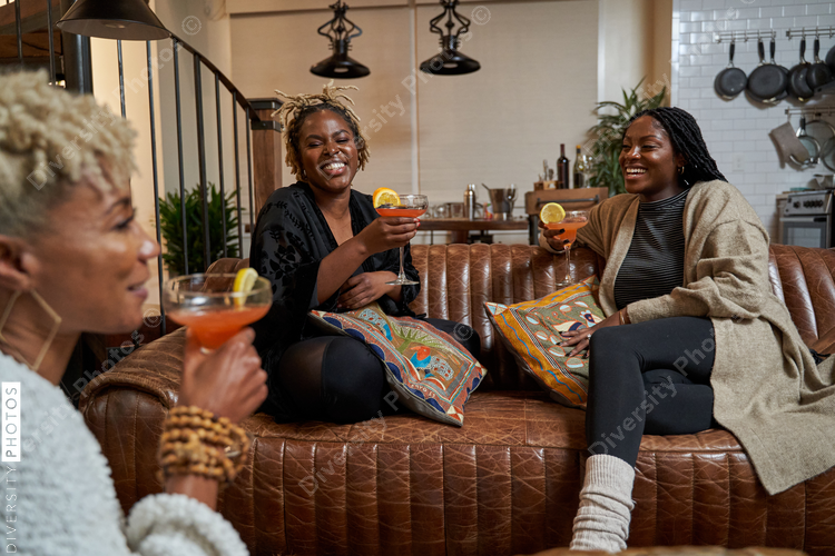 Black girlfriends talking at home during cozy self care retreat