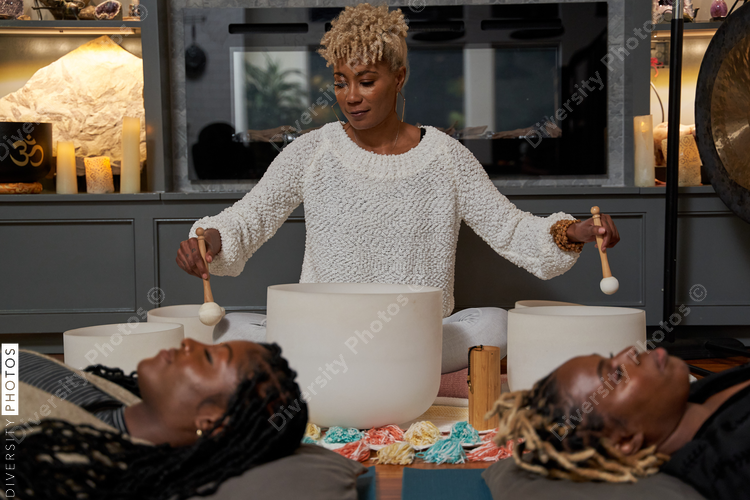 Black women having peaceful mediation laying down, self care retreat