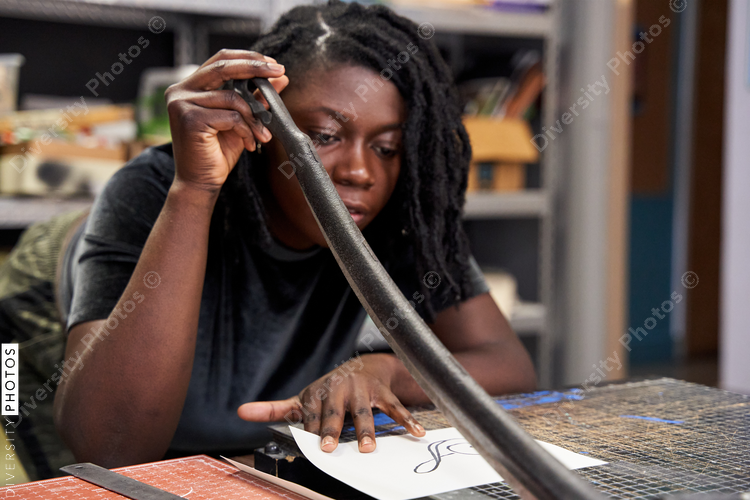 Black woman using cutting board, artist DIY project
