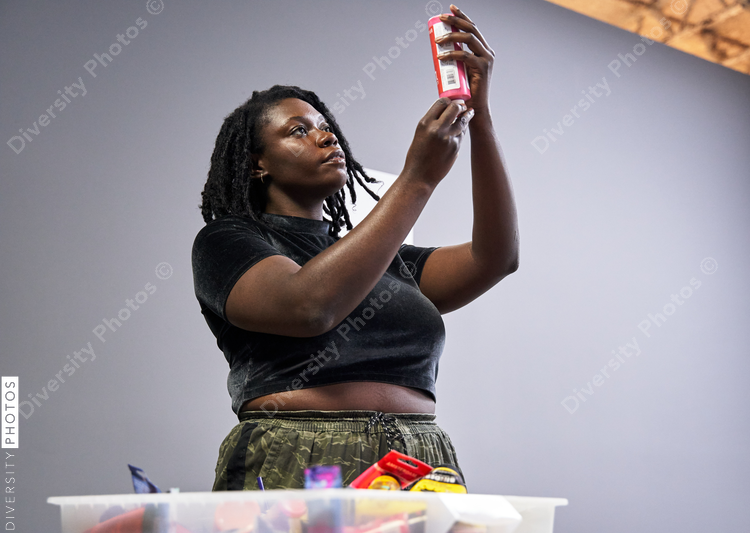 Black woman preparing paint for art project