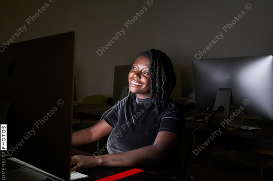 Black woman college student studying in computer lab
