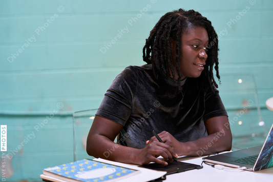 Black graphic design artist creative working on school project, on laptop