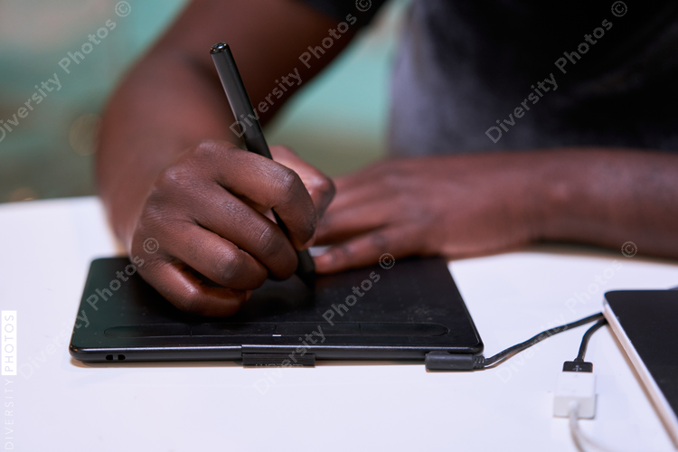 Black graphic design artist creative working on school project, on laptop