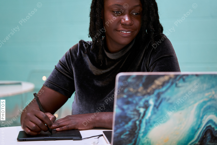 Black graphic design artist creative working on school project, on laptop