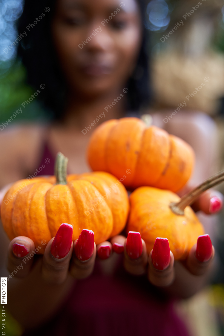 Black woman explores outdoor pumpkin patch, nature