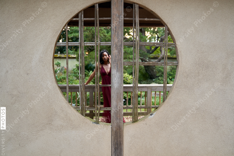Black woman behind the wall, with copy-space