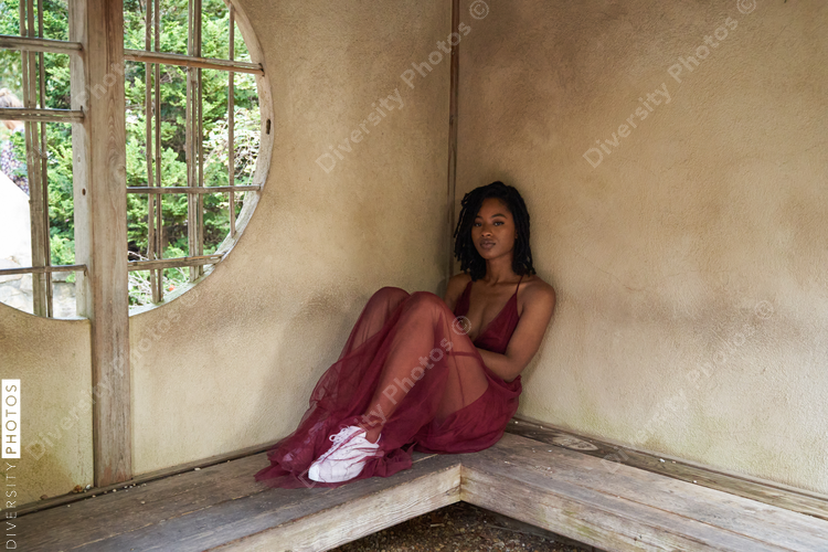 Portrait of pretty Black woman against brown wall, mid adult