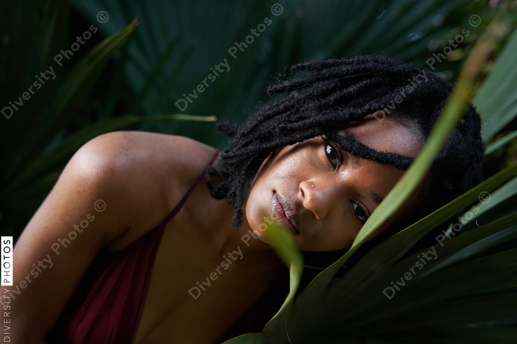 Portrait of confident African American woman with plants