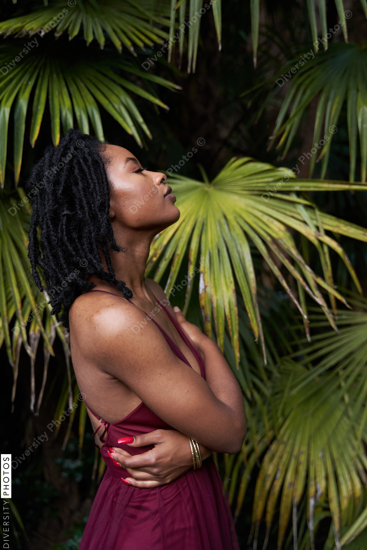 Portrait of African American woman with plants, self-love