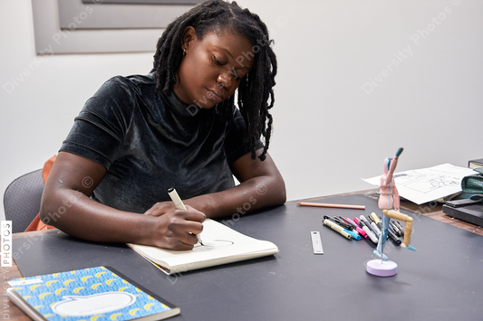 Black female artist creative drawing in studio