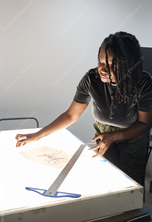 Black female artist creative drawing in studio