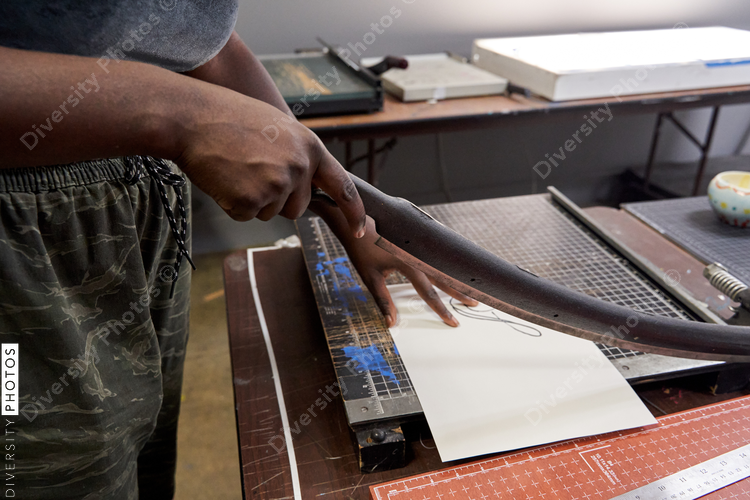 Black woman using cutting board, artist DIY project