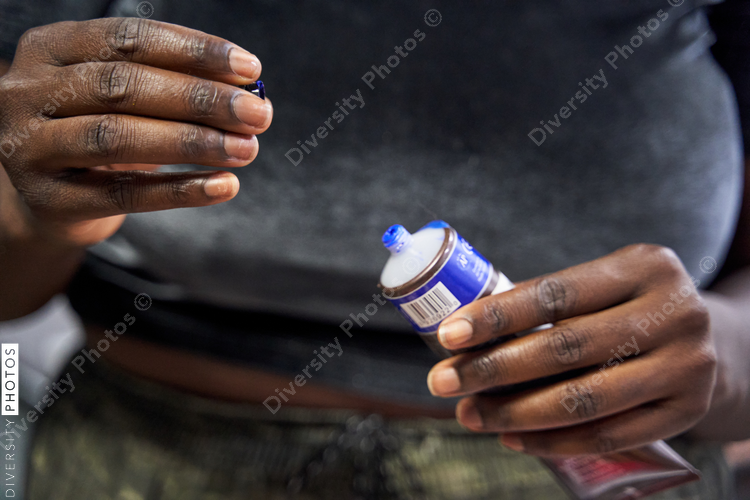 Black woman preparing paint for art project