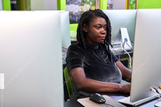Black woman college student studying in computer lab