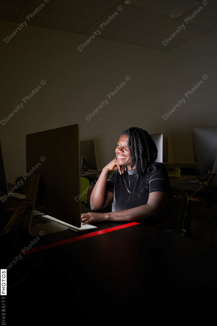 Black woman college student studying in computer lab