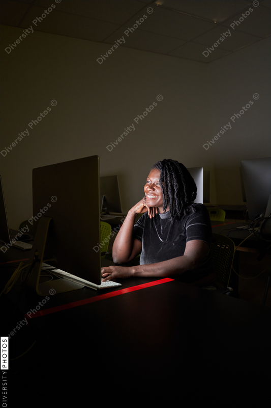 Black woman college student studying in computer lab