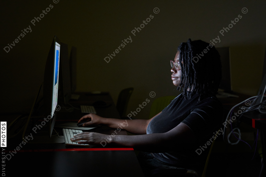 Black woman college student studying in computer lab