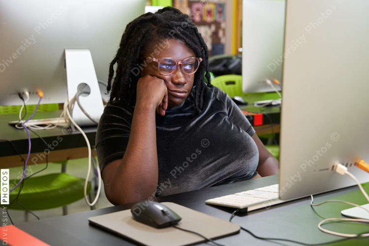 Black female college student bored in computer lab