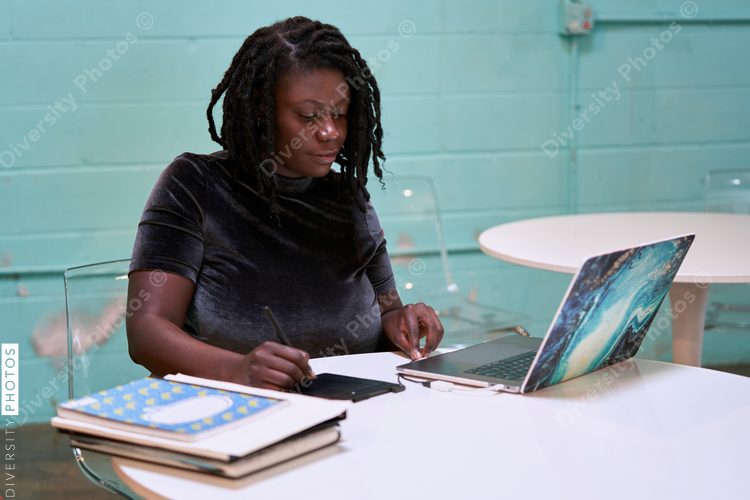 Black graphic design artist creative working on school project, on laptop
