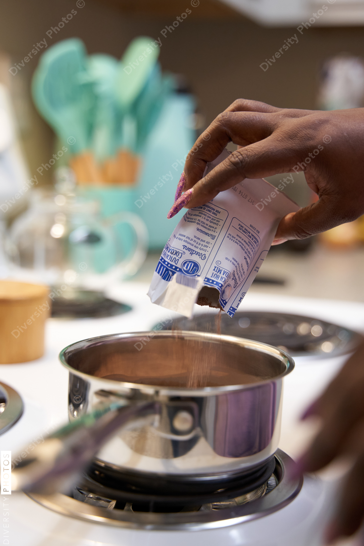 Black woman making hot chocolate at home