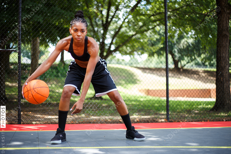 Portrait of woman playing basketball