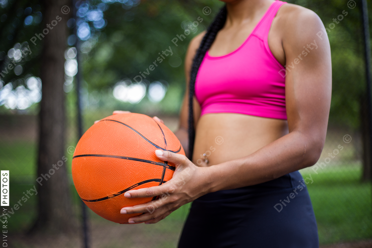 Close up view of woman holding basketball