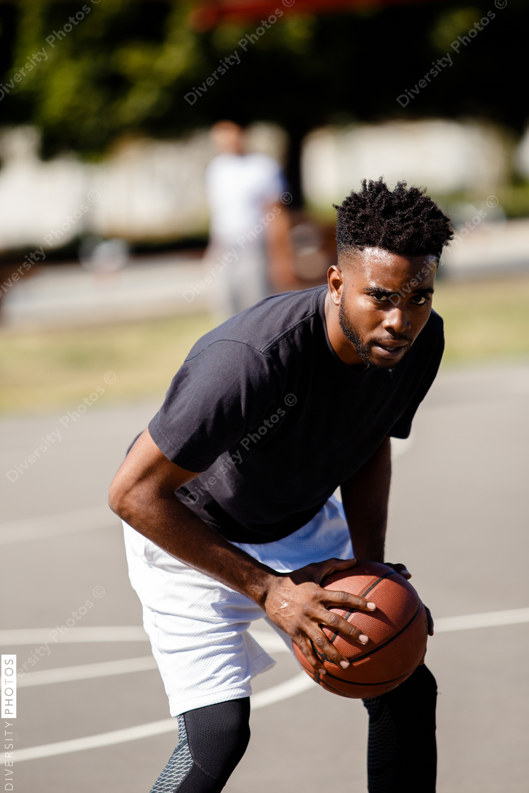 Young black man playing basketball