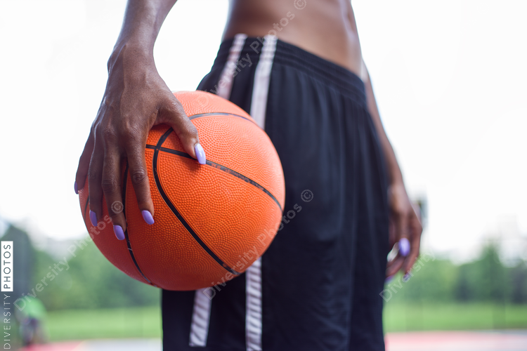 Close up view of woman holding basketball