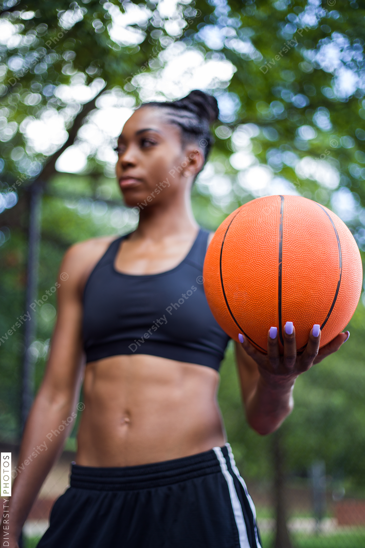 Low angle view of woman holding basketball