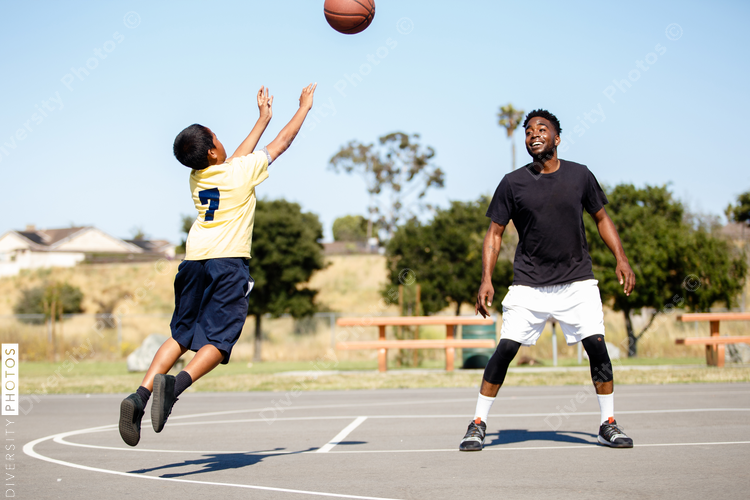 Two diverse people playing pickup basketball