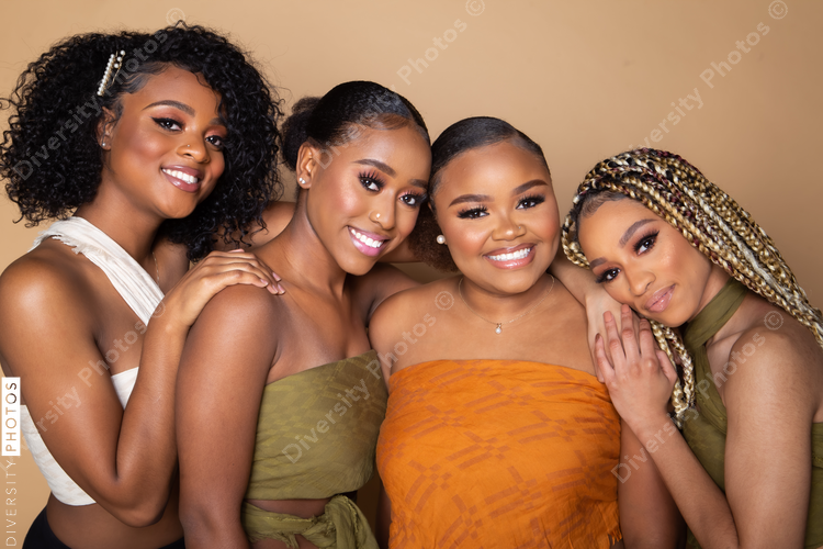 Studio portrait of four happy beautiful black female friends