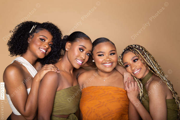 Studio portrait of four happy beautiful black female friends