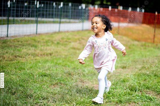 Young toddler running and enjoys the outdoors