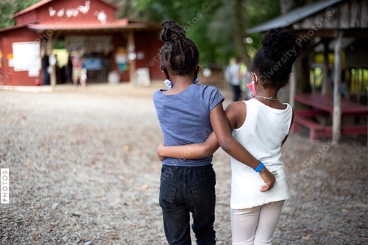 Best friends walking on family farm