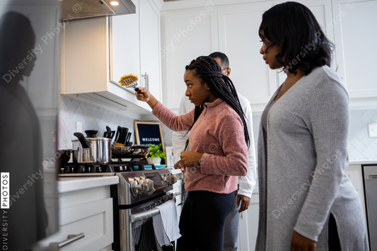 Black Family bonds cooking breakfast at home