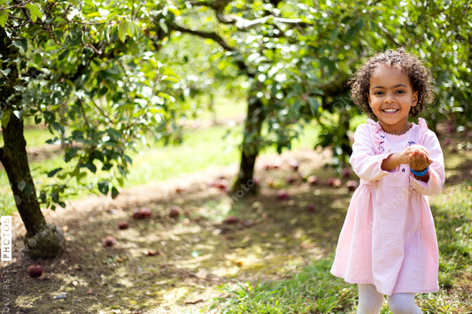 Young girl playing outside on fruit farm