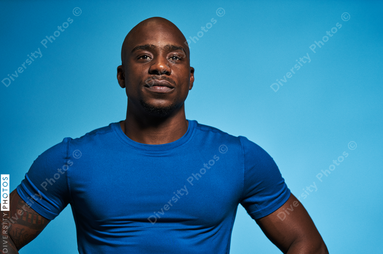 Portrait of athletic man in studio on blue background