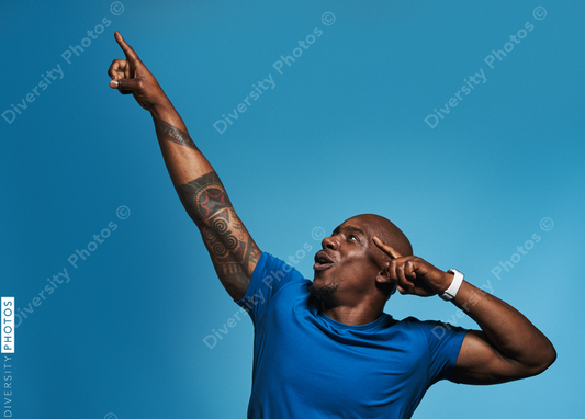 Black man celebrating victory in studio portrait