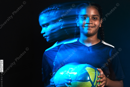 Young female soccer player in motion colorful portrait