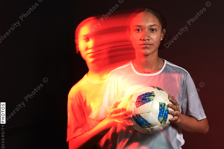 Young female soccer player in motion colorful portrait
