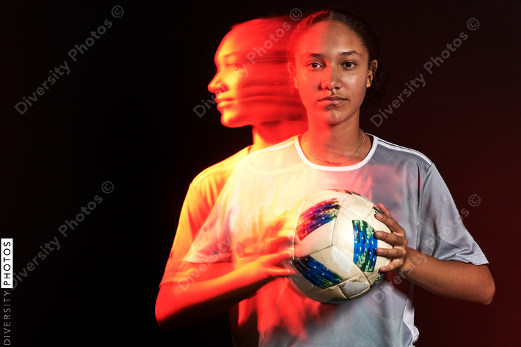 Young female soccer player in motion colorful portrait
