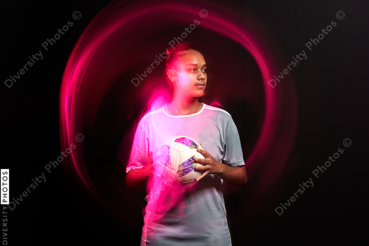 Young female soccer player in motion colorful portrait