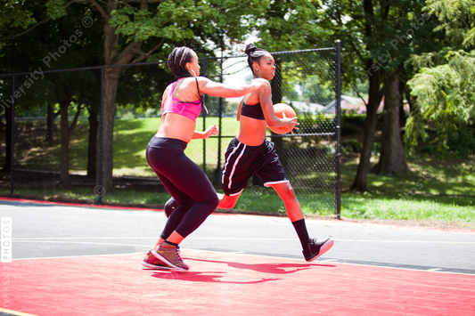 Women playing on basketball court