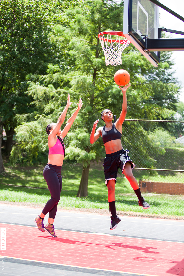 Woman throwing basketball into net