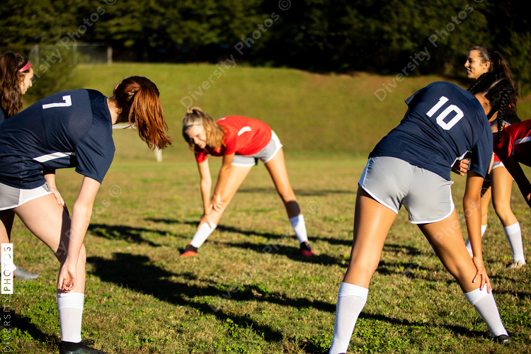 Girl soccer team stretches and warm up for scrimmage game