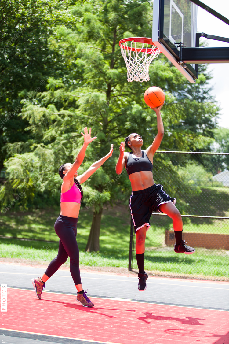 Woman throwing basketball into net