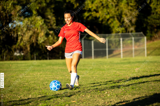 Young girls playing soccer scrimmage game