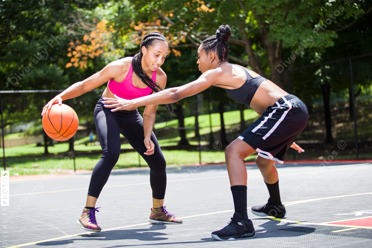 Women in sporting dress playing basketball