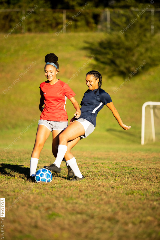 Young girls playing soccer scrimmage game